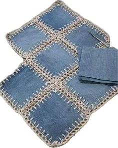 three pieces of blue denim with white stitching