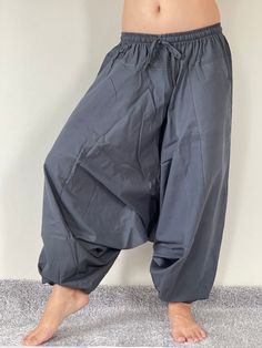 "Harem Pants Ethically Made in Thailand, Low crotch yoga pant, Unisex harem pants, Gorgeous Harem Pants, Lounge & Yoga Trousers Thai Cotton harem pants have the \"flow\", perfect for yoga or just a cool strolling. Comfort and character are what these pants are all about. They have the traditional sarong look & feel but a lot more practical when it comes to activities like yoga. As a bonus, they are convertible! Just pull them up and you get yourself a cute jumpsuit in a flash. Together w Yoga Harem Pants With Drop Crotch, Yoga Harem Pants With Drop Crotch And Relaxed Fit, Relaxed Fit Drop Crotch Harem Pants For Yoga, Stretch Harem Pants For Yoga, Ankle-length, Baggy Yoga Pants With Drop Crotch, Stretch Ankle-length Harem Pants For Yoga, Cotton Harem Yoga Pants, Stretch Cotton Harem Pants For Yoga, Cotton Drop Crotch Harem Pants For Yoga