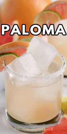 a close up of a drink in a glass with ice and watermelon slices