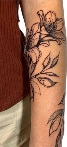 a woman's arm with flowers on it