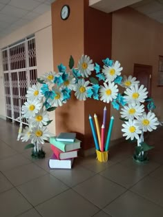 flowers and books are arranged on the floor