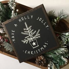 there is a sign that says have a holly jolly christmas with pine cones on it