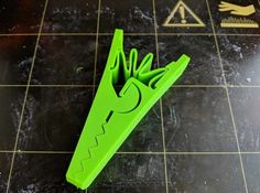 a green knife holder sitting on top of a tiled floor