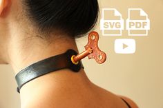 a woman wearing a black leather bracelet with an orange chain attached to the back of her neck