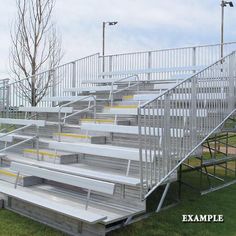 an empty stadium bleachers sitting in the grass