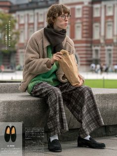 a man sitting on a bench holding a paper bag