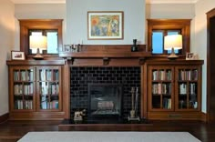 a living room filled with furniture and a fire place in front of a book shelf