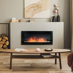 a living room with a fire place on the wall and a painting hanging above it