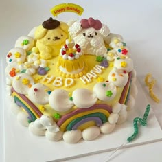 a birthday cake with white frosting and colorful decorations