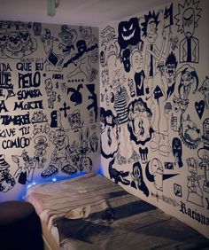 a bed room with a neatly made bed and wall covered in cartoon drawings on the walls