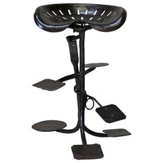 a black metal stand with several different items on it's legs and feet,