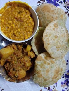 a plate full of food including bread and soup