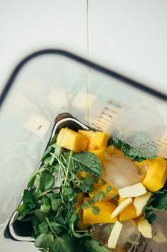 a blender filled with fresh fruit and vegetables