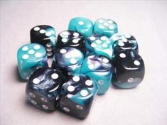 blue and black dices with white dots on the top are lined up in a pile