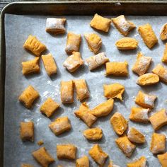 there are many pieces of food on the baking sheet