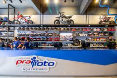 people are sitting at the counter in a motorcycle shop