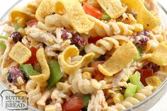 a glass bowl filled with pasta salad