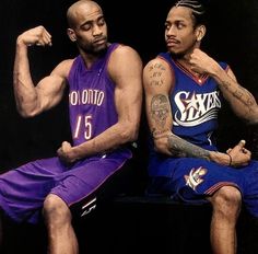 two basketball players sitting next to each other with tattoos on their arms and legs, one holding his fist up