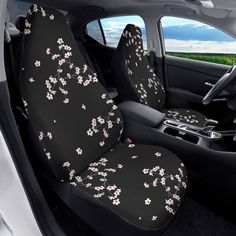 the interior of a car with black and white flowers on it's seat covers