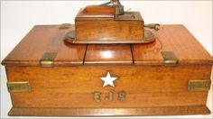 an old wooden box with a star on the lid and two sides that say us