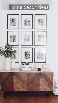 a living room with pictures on the wall and wood flooring, including a sideboard