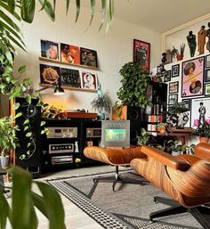 a living room filled with furniture and lots of plants