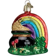 a glass ornament with a rainbow and mushroom in the center on a white background