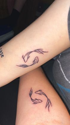 two people with matching tattoos on their arms