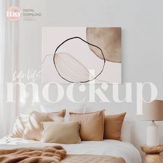 a bed with pillows and blankets on top of it next to a painting that says mock mockup