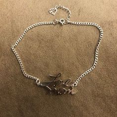 a silver bracelet with the word love on it and an elephant charm attached to it