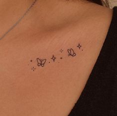 a woman's chest with three butterflies on it