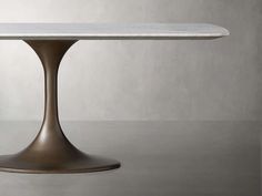 an oval table with a white marble top and metal base, against a gray background