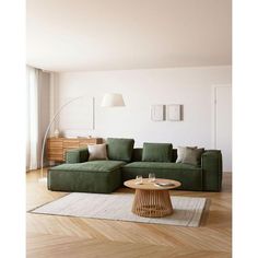 a living room with a green couch and coffee table