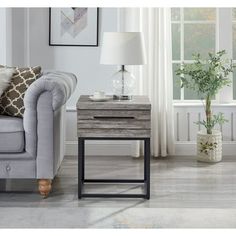 a living room scene with focus on the end table and sofa in the foreground