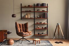 a living room with a chair and shelves on the wall