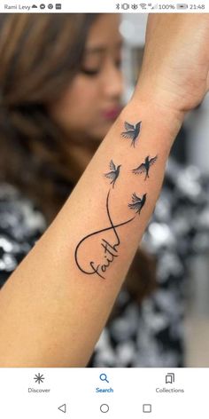 a woman with a tattoo on her arm that says love and birds flying in the air