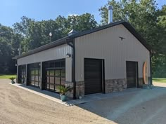 a large garage with two doors on the front and one door open to let in lots of light