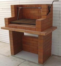 a bench made out of bricks sitting in front of a building