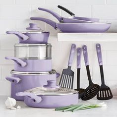 purple pots and pans are stacked on top of each other