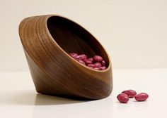 a wooden bowl filled with pink candy beans