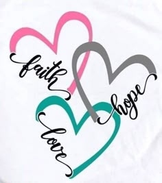 two hearts with the words faith and hope in different colors on white fabric, closeup