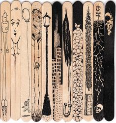 a row of wooden skateboards with drawings on them