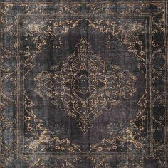 an antique rug with black and gold colors