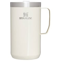 the stanley travel mug is white and has a stainless steel lid with a silver handle