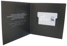 an open black book with white writing on it and a sticker that says cards