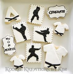 decorated cookies in the shape of baseball players are displayed on a white tray with black lettering