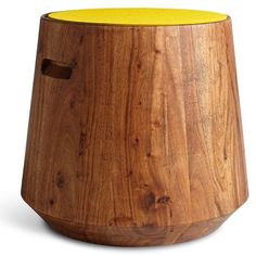 a wooden vase sitting on top of a white surface