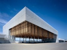 the building is made out of bamboo sticks and has a roof that looks like it's covered in wood slats