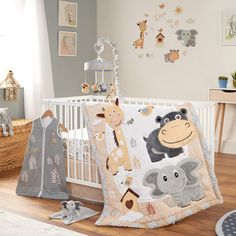 a baby crib bedding set with animals and giraffes on it