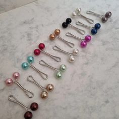 These clips are secure and have a simple yet elegant look to them. They won't create holes in your favourite hijabs like the average pin does. We have 13 gorgeous colours to offer. With a smooth pearl finish, these clips will elevate any hijab style. Price: Pack of 8 - £2.50 (Colours will be picked at random) -We also have these in other colour tones- Feel free to ask any questions. Message us to order now 💜💜 #abaya #jilbab #womenclothing #muslim #muslimahfashion #modestfashion Hijab Pins Accessories, Hijab Box Design, Hijab Clips, Fancy Abaya, Hijab Veil, Scarf Pins, Hijab Accessories, قلادات متدلية